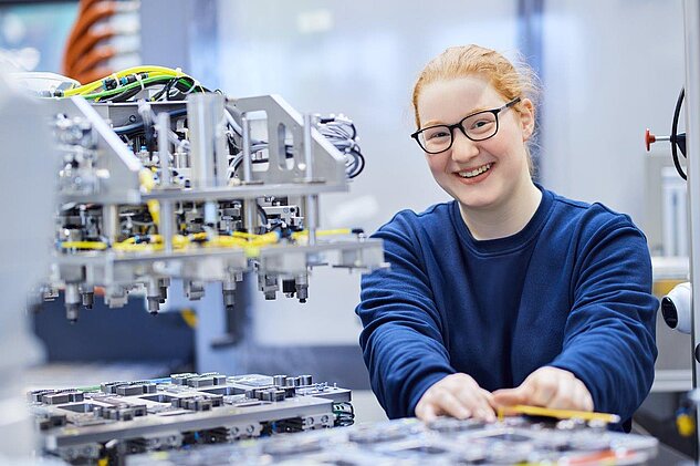 female apprentice working in assembly