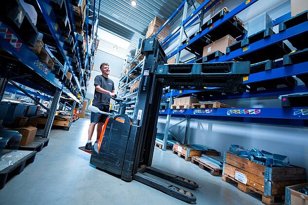 Logistics Specialist using a forklift to move palettes