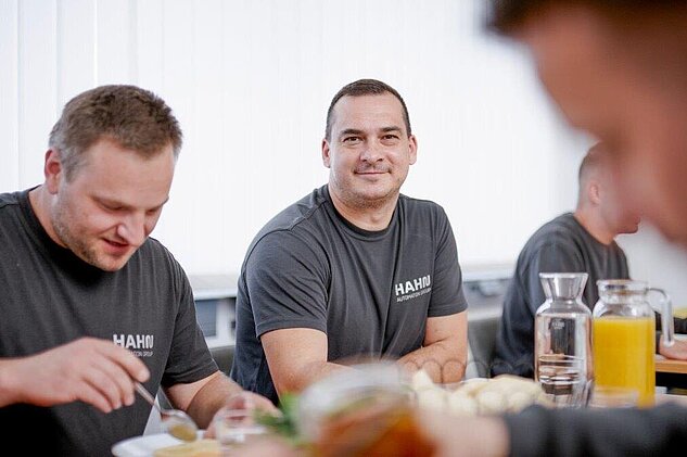 employees having breakfast together in the canteen