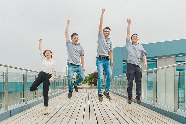 four employees together jumping