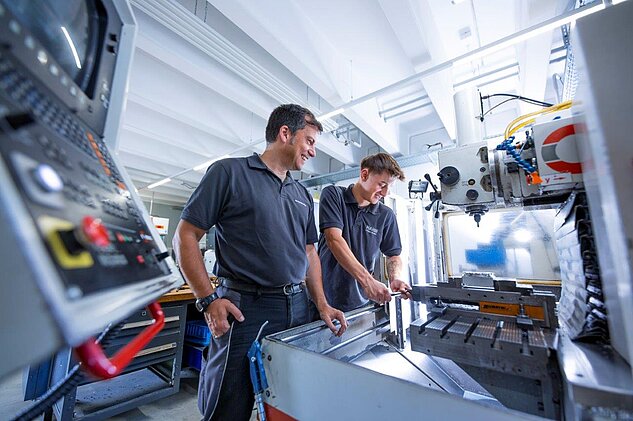 Machinist Apprentice on the milling machine with his trainer