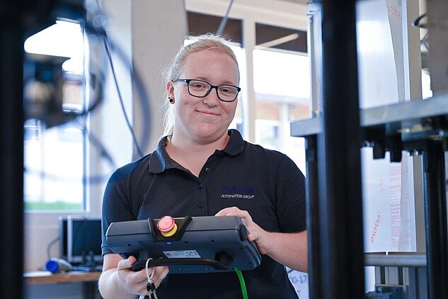 female programmer with robot panel