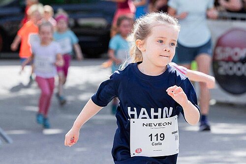 Young girl running at the Market Run in Kremsmünster