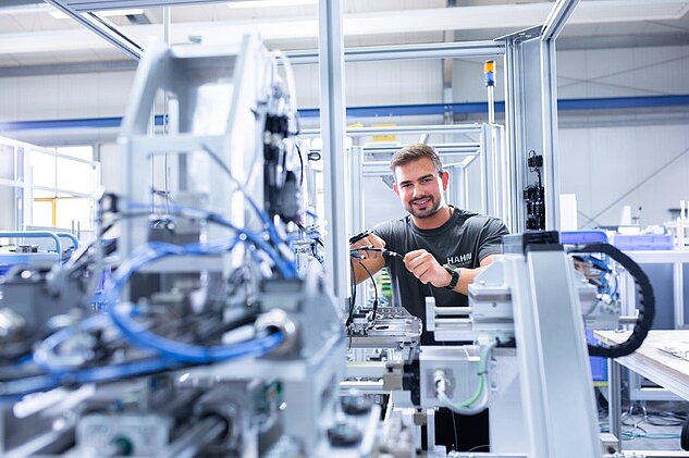 Mechatronics Technician Apprentice working in module assembly on a cell